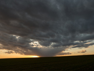 dark clouds red sun at sunset day