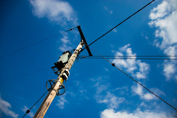 High voltage power lines against blue sky