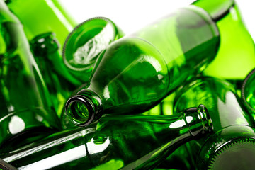 A bunch of empty green glass bottles collected for recycling sale. Waste management concept.
