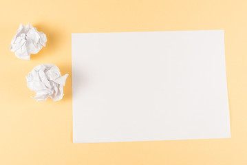White empty sheet of paper on beige background.