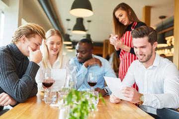 Group of young people when ordering in the restaurant