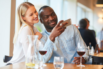 Amorous multicultural couple is taking a selfie