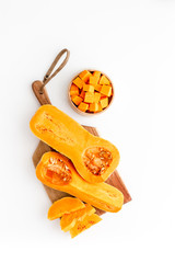 Pumpkin - slices on cutting board - on white background top-down