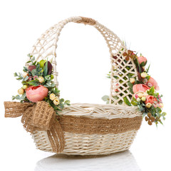 Fototapeta na wymiar Easter oval basket on white background. Decorated with flowers in pink and greenery. Decorated with sacking.