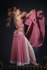 A little girl dressed as an belly dancer