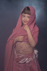 A little girl dressed as an belly dancer