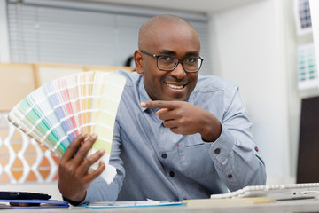 man picking a color for house walls