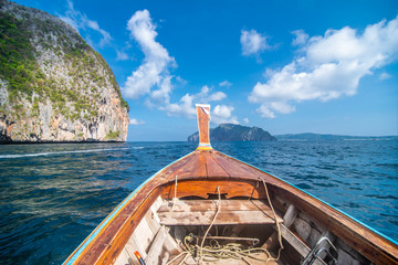 Traditional wooden longtail taxi boat nose with decoration flowers and ribbons at Maya Bay beach...