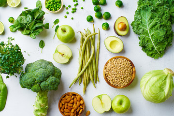 Pattern flat lay with healthy vegetarian meal ingredients. Raw food concept. A variety of organic fruits and vegetables with avocado. Vegan menu.