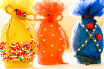 Colorful Easter eggs in colored lace on a light background
