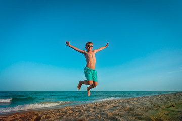 Fototapeta na wymiar happy little boy play on beach, kid enjoy sea