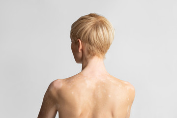 Portrait of european woman posing naked, back