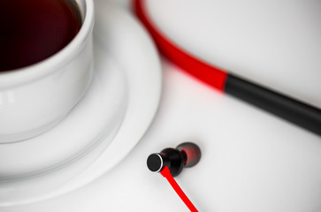 Headphones for mobile phones on wooden background.
