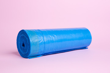 Roll of blue garbage bags on a blue background