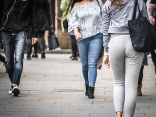 Anonymous people walking on city street