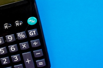 Black calculator on a blue background