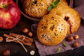 Delicious small sweet pies filled with apples, cinnamon and hazelnuts