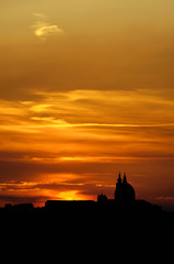 Sunset over the Basilica of the Holy House (Santa Casa) in Loreto (AN) Italy, silhouette of the skyline.
