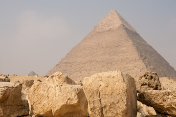 Fototapeta na wymiar Egypt pyramid on the background with big stone blocks in foreground