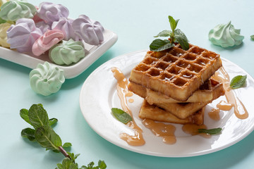 Viennese waffles with caramel topping. Still-life. Sweets, dessert with coffee.