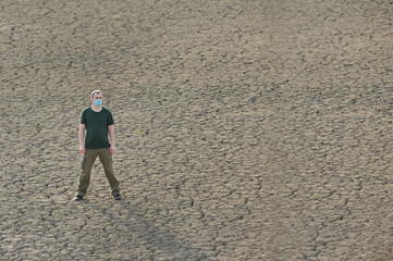 Man Alone On Cracked Soil