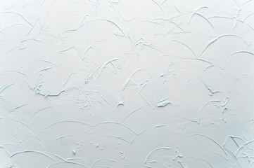 the texture of decorative plaster is light blue. Scratches and relief on the wall. Background.
