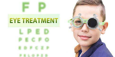 Child eye treatment. Boy while vision treatment, wearing special glasses.