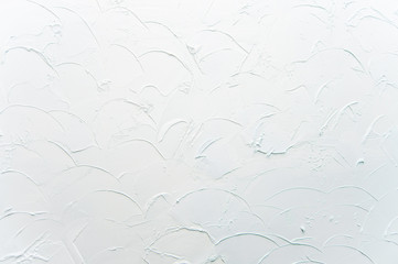 the texture of decorative plaster is light blue. Scratches and relief on the wall. Background.