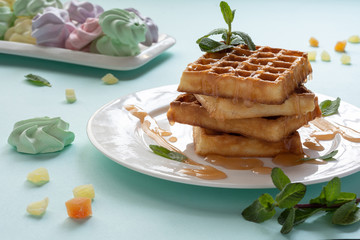 Viennese waffles with caramel topping. Still-life. Sweets, dessert with coffee.