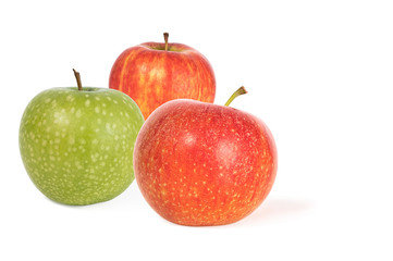 three red and green ripe juicy apples isolated on a white background