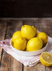 Group of fresh lemons on an old vintage wooden table