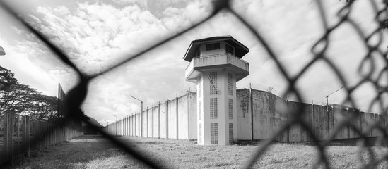 Prison with iron fences.Prison or jail is a building where people are forced to live if their...