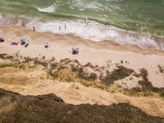 Aerial view of sandy beach and sea with waves