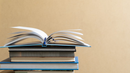 Books and textbook on wooden desk in library selective focus , Piles of books on reading desk in school with copy space for text.World book day and education concept.