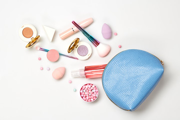 Beauty cosmetics makeup product flying. Woman make up, brushes lipstick blush falling in cosmetic bag. Creative fashion concept. Cosmetology make-up set fly, levitation.