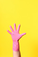hand with glove, palm, on yellow background