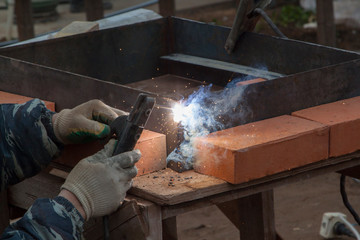 raftsman connects metal plates with electric welding for further use of the structure
