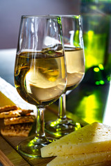 Glasses of dry fino sherry wine served with spanish tapas, manchego cheese, green olives, cheese crackers