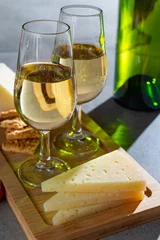 Fotobehang Glasses of dry fino sherry wine served with spanish tapas, manchego cheese, green olives, cheese crackers © barmalini