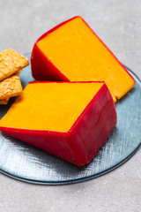 Red waxed yellow cheddar cheese close up