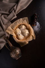 Traditional georgian dampling known as khinkali in georgian on dark concrete table with copy space
