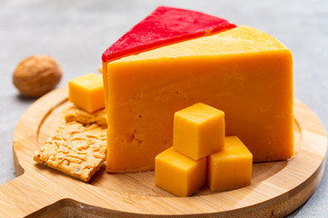 Matured yellow and red waxed cheddar cheese close up