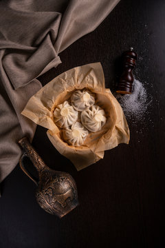 Traditional georgian dampling known as khinkali in georgian on dark concrete table with copy space