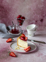 Piece of cheesecake decorated with fresh strawberries in a plate. Copy space