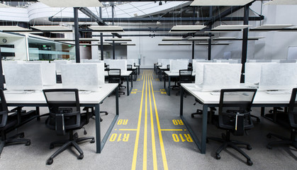 Big office with covered computers with no workers