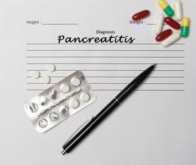 Pancreatitis diagnosis written on a white piece of paper.