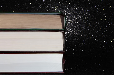 Closed thick book. A stack of pages on a black background.