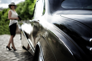 Automobile. Woman. Antique car.