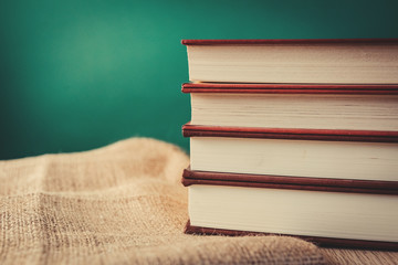 Books on wooden shelf with vintage backgrounds