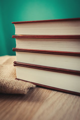 Books on wooden shelf with vintage backgrounds